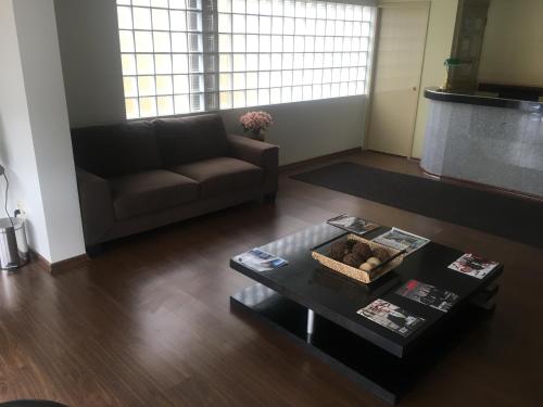 a living room with a couch and a coffee table at Los Sauces Apart Hotel in La Paz