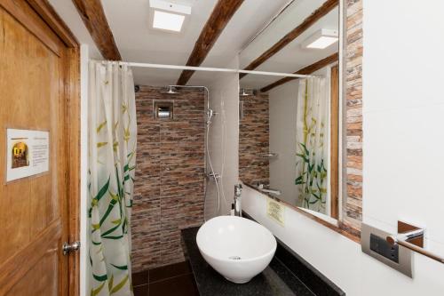 a bathroom with a white toilet and a mirror at Casona les Pleiades in Cusco