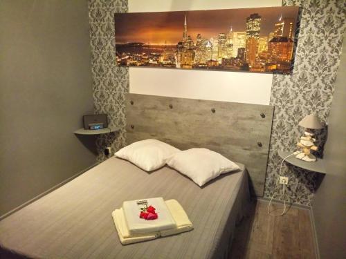 a bedroom with a bed with a tray with roses on it at Appartement Houlet in Tillé