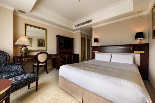 a bedroom with a bed and a desk and a chair at Dai-ichi Hotel Tokyo in Tokyo
