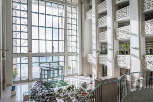 a large lobby with large windows and a staircase at LeoPalace Resort Guam in Yona