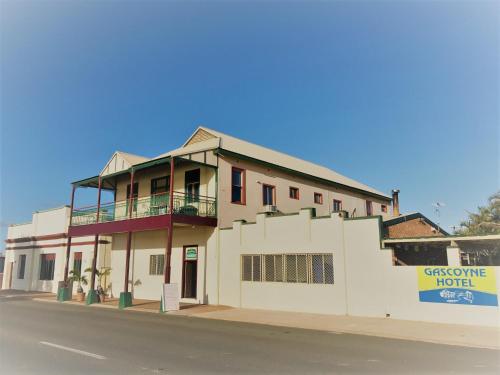 a building with a sign on the side of it at Gascoyne Hotel in Carnarvon