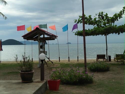 a group of colorful flags on the beach at Happy Days Resort in Ko Mak