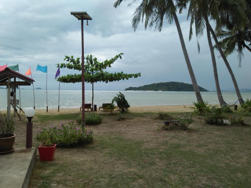 a view of the beach with palm trees and the ocean at Happy Days Resort in Ko Mak