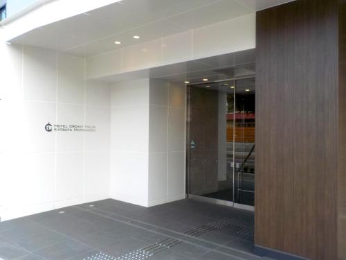 a bathroom with a glass shower in a building at Hotel Crown Hills Katsuta Nigo Motomachiten in Hitachinaka