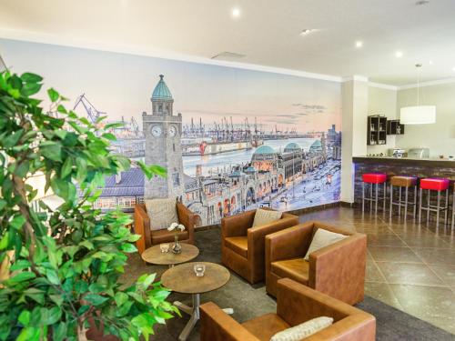 a lobby with a mural of a clock tower at Hotel Domicil Hamburg by Golden Tulip in Hamburg