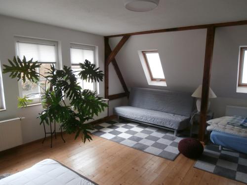 a living room with a couch and a checkered floor at Ferienwohnung Saaleblick in Halle an der Saale