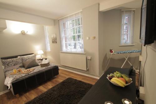 a living room with a couch and a table at Molesey Apartments in London