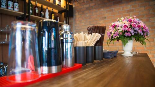 a table with a vase of flowers and a vase of flowers at The Rodman Hotel in Chiang Mai
