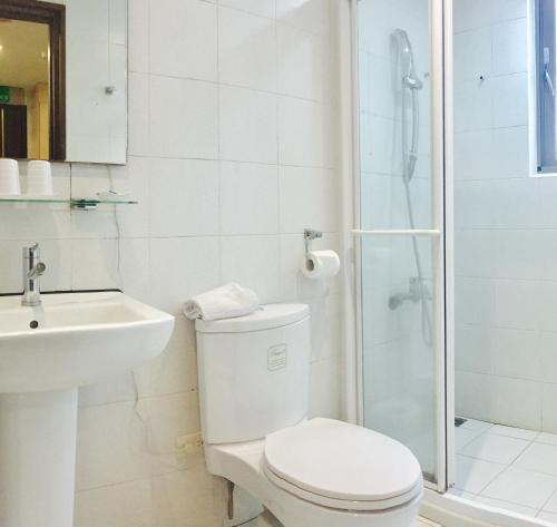 三峽區的住宿－熊旅溫泉飯店，白色的浴室设有卫生间和淋浴。
