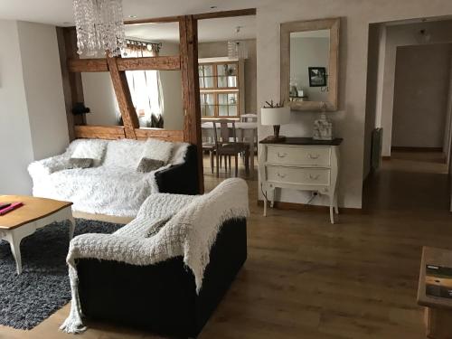 a living room with a bed and a table at Les Authentics - La Maison d'Amélie in Riquewihr