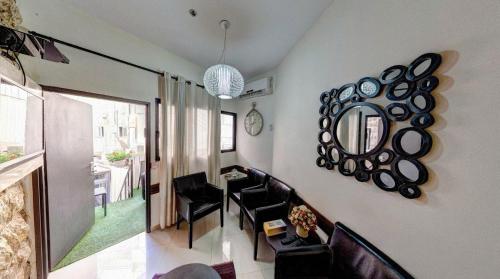 a living room with chairs and a mirror on the wall at City Center Jerusalem in Jerusalem