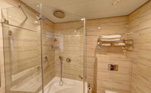 a bathroom with a shower and a glass shower stall at City Center Jerusalem in Jerusalem