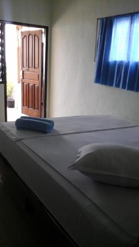 a close up of a bed in a room at Beach Guest House in Maninjau