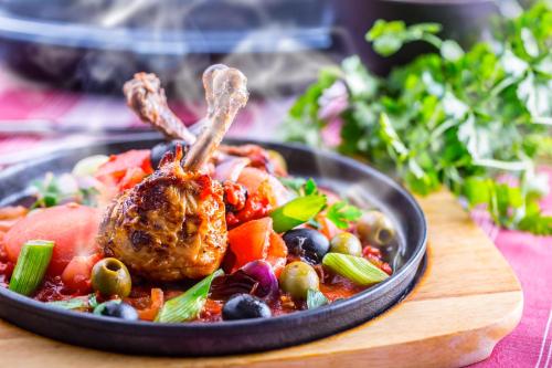 a plate of food with a chicken on top of vegetables at Ski & Wellness Residence Družba in Demanovska Dolina