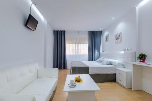 a white room with a bed and a couch at Boutique Urban Madrid Serrano in Madrid