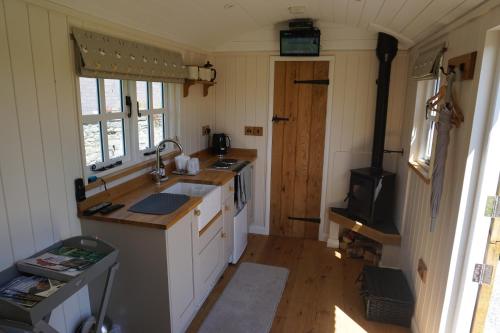 a small kitchen with a sink and a stove at Nutgrove House Luxury B&B in Seaforde