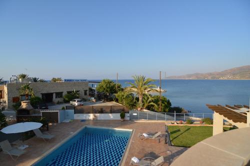 a house with a swimming pool and a view of the water at Kalli Villa in Pomos