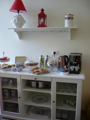 a kitchen counter with food and dishes on it at B&B Excelsior in Lecce