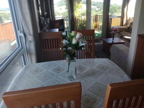 un jarrón de flores sobre una mesa en la sala de estar en Warren View en Dawlish