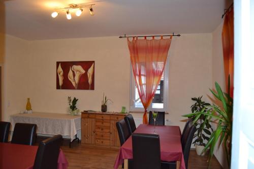 a dining room with a table and chairs and a table and a table at Jakobshof in Freckenfeld