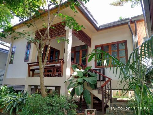 a house with a staircase in front of it at Reuan Phaolai in Bophut