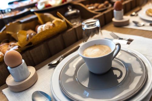a cup of coffee on a plate on a table at Al Pescatore - B&B in Bari