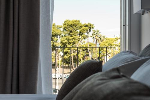 a person sitting on a couch looking out a window at Al Pescatore - B&B in Bari