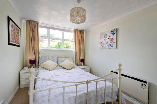 a bedroom with a white bed and a window at Saurden Guest Apartment in Ipswich