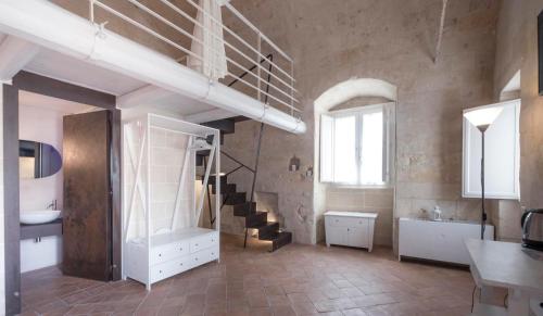 a bathroom with a staircase and a sink in a room at Le Dimore Dell' Idris in Matera