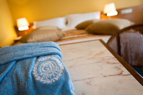 a pair of jeans sitting on top of a bed at Grand Hotel Trieste & Victoria in Abano Terme