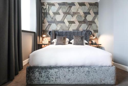 a bed that has a blanket on top of it at Malmaison Hotel Leeds in Leeds