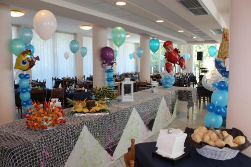 a banquet hall with tables with blue and purple balloons at Hotel Beverly in Rimini