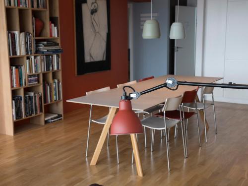 a table with chairs and a red lamp in a room at Reykjavík Central Apartments in Reykjavík
