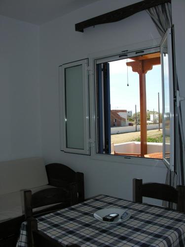 a room with a table and a window with a plate on it at Joanna Apartments in Mikri Vigla