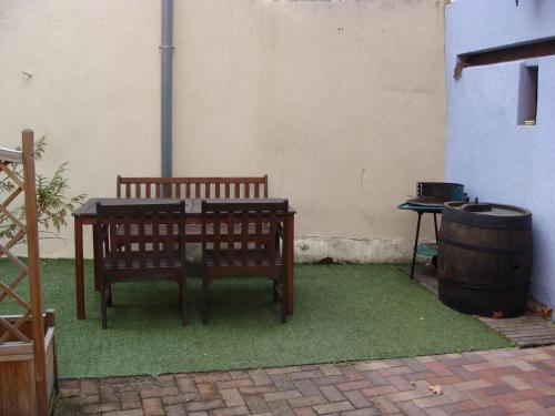a table and a bench sitting next to a barrel at la grange de louis in Turckheim