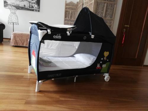 a black baby car seat in a room at La Loggia Al Duomo - Treviso in Treviso