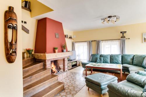 a living room with a couch and a fireplace at Amazing 5 bedroom house KRUMLOV 82 - 4 min walk to main square in Český Krumlov