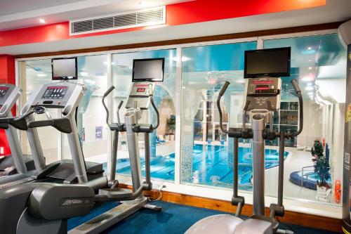 a gym with cardio machines in front of a window at Oriel House Hotel in Cork