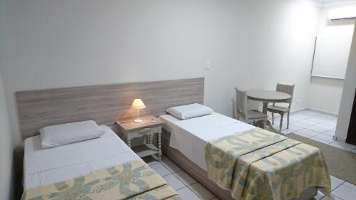 Tempat tidur dalam kamar di Hotel Premium Flat Ourinhos