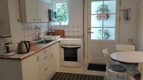a kitchen with a sink and a stove at Royaltybed Copenhagen in Copenhagen