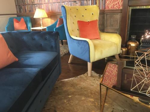 a living room with a couch and a chair at Virginia Court Hotel in Cromer
