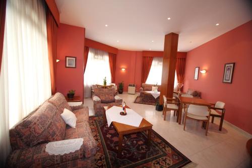 a living room with a couch and a table at Hotel Ramos in Silleda