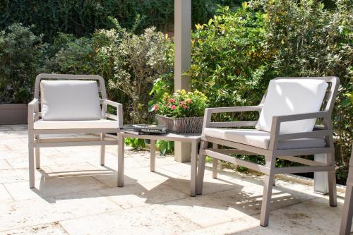 two chairs and a table on a patio at Domus Il Palio in Siena
