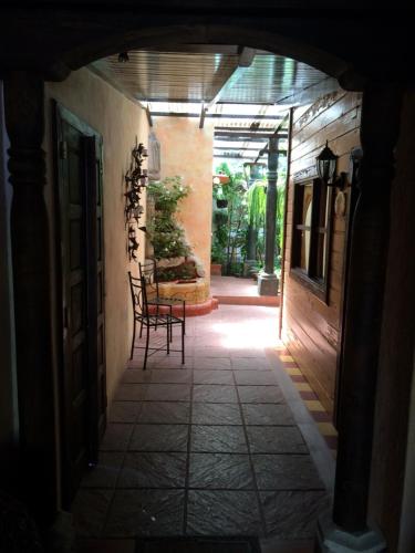 a hallway with a table and chairs in a building at Posada De Los Volcanes in Panajachel
