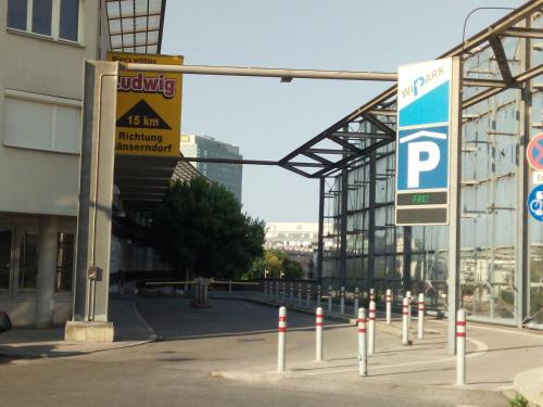 a parking lot with a parking sign in front of a building at Apartment Paradies - U1 Station altes Landgut in Vienna