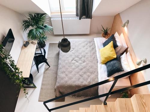 a living room with a couch and plants at Latroupe Hotel Jardin Secret in Brussels