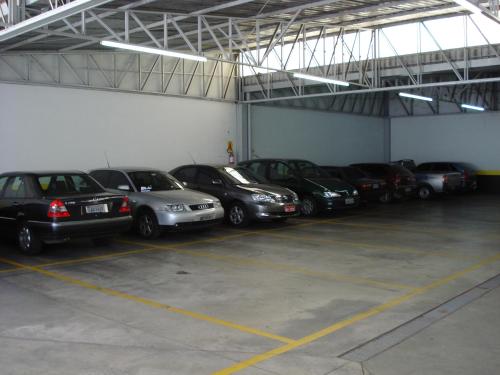 a group of cars parked in a garage at Hotel Premium Flat Ourinhos in Ourinhos