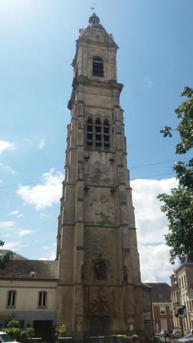 a tall tower in front of a building at Apt 6 du Temple 2 chambres & Parking in Cambrai