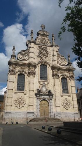a large stone building with a clock on it at Apt 6 du Temple 2 chambres & Parking in Cambrai